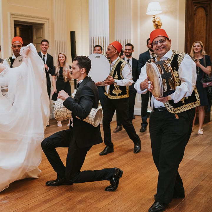 Bride and groom dance with their wedding entertainment Zaffa band 