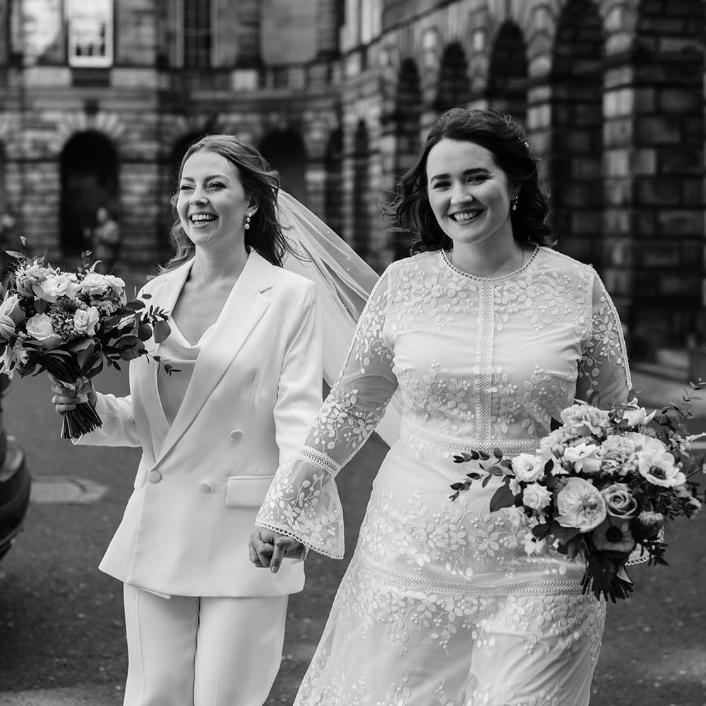 Brides leave ceremony in black and white image