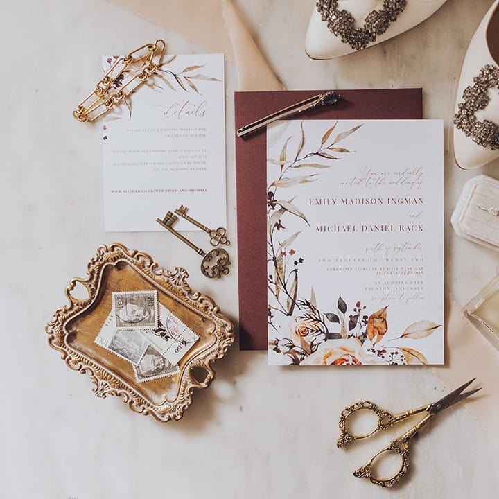 Classic wedding stationery beside Manolo Blahnik bridal shoes and Chanel No.5 perfume