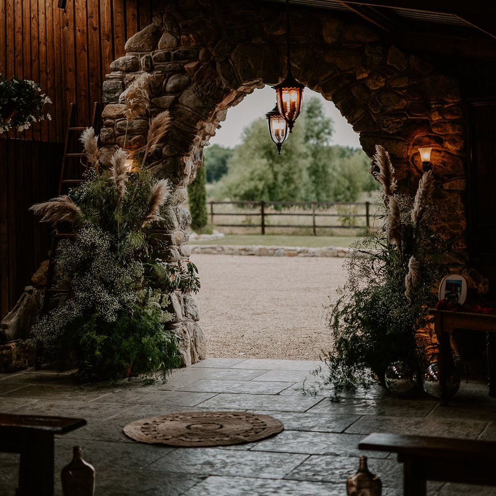 Pampas grass and gypsophila flower column arrangements decorating the Willow Marsh Farm wedding venue 