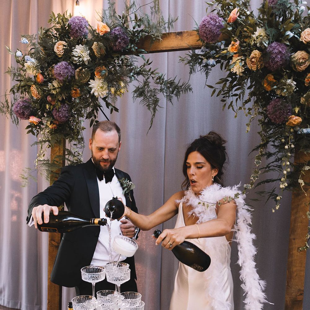 Champagne tower wedding decoration that topples over as the bride and groom pour in champagne 