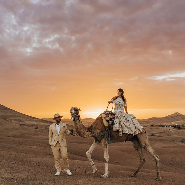 Romantic sunset wedding photography at desert elopement with camels 