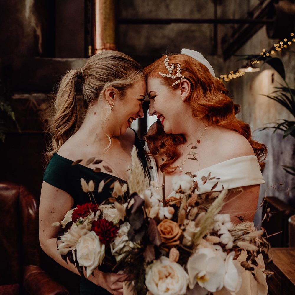 Bride with vintage wedding hair and bridesmaid in black dress