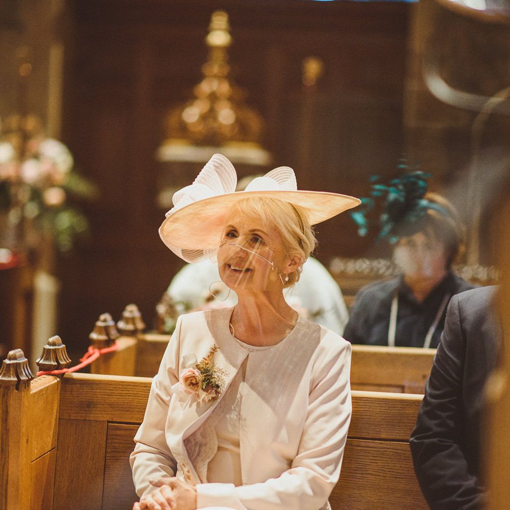 Mother of the groom in a grey hat a fan visor 