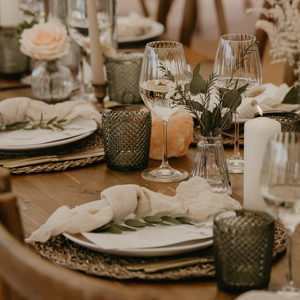 Rustic wedding tablescape on wooden table complete with candles and woven placemats  | Mark Bamforth Photography