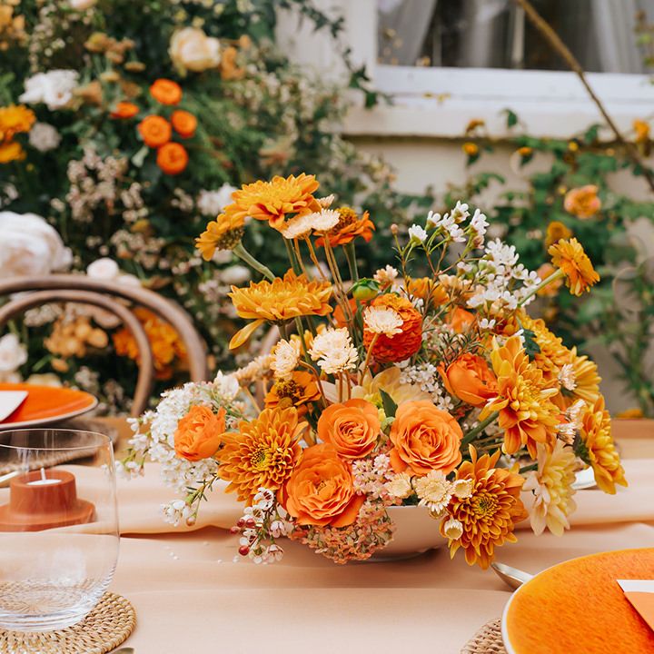 Orange flower centrepiece with dahlias, ranunculus and carnations 