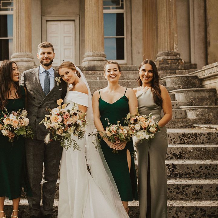 Bride & groom stand with bridesmaids on their wedding day 