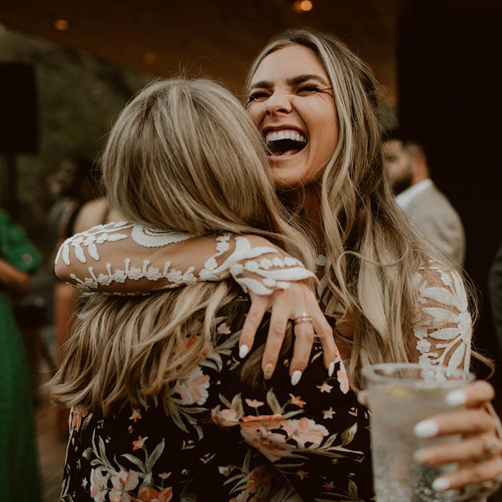 Bride hugs wedding guest