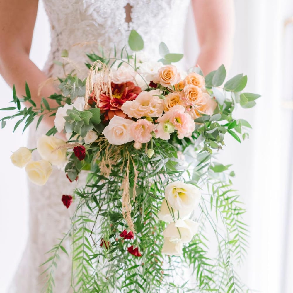 Beautiful bouquet of blush roses, carnations and wild foliage at LGBTQI+ wedding