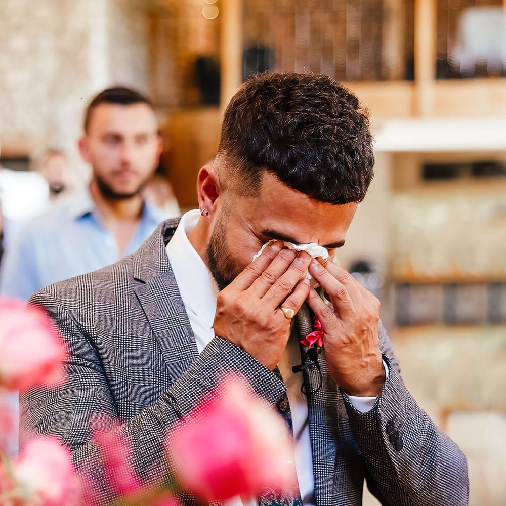 Groom becomes emotional as his bride walks down the aisle at Priston Mill on their wedding day