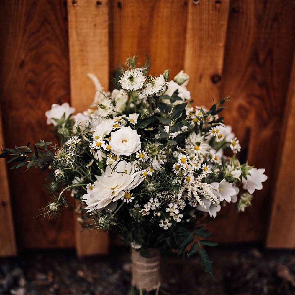 Pretty white flower wedding bouquet for a rustic barn wedding 