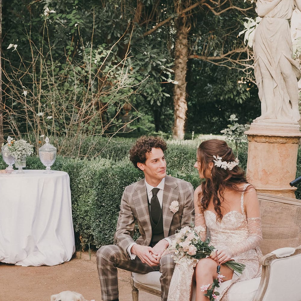 bride in a gold sparkly wedding dress and groom in a grey check suit at outdoor wedding ceremony at Carmen de los Mártires wedding venue in spain