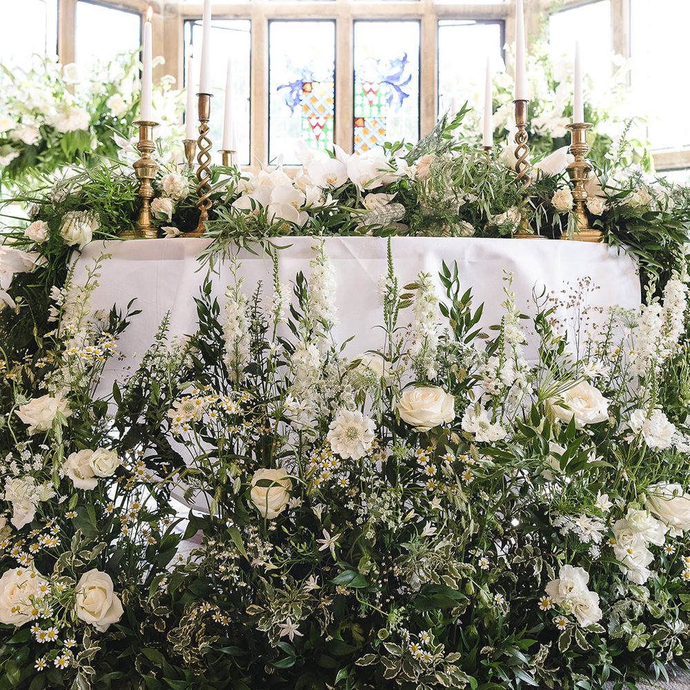 Extravagant wedding flowers with classic white and green colour scheme including roses and orchids 