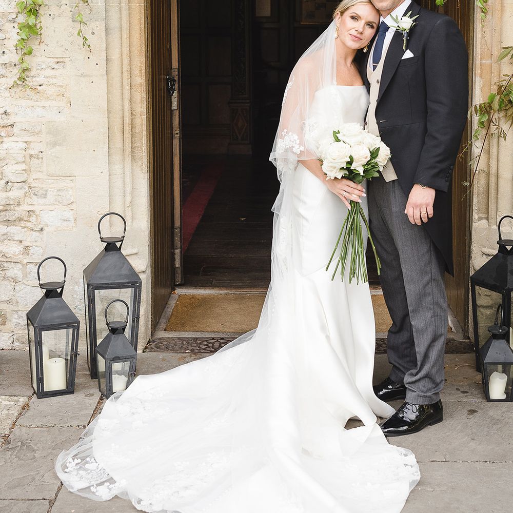 Bride in mermaid wedding dress in sleek material with the groom in morning suit for country house wedding 