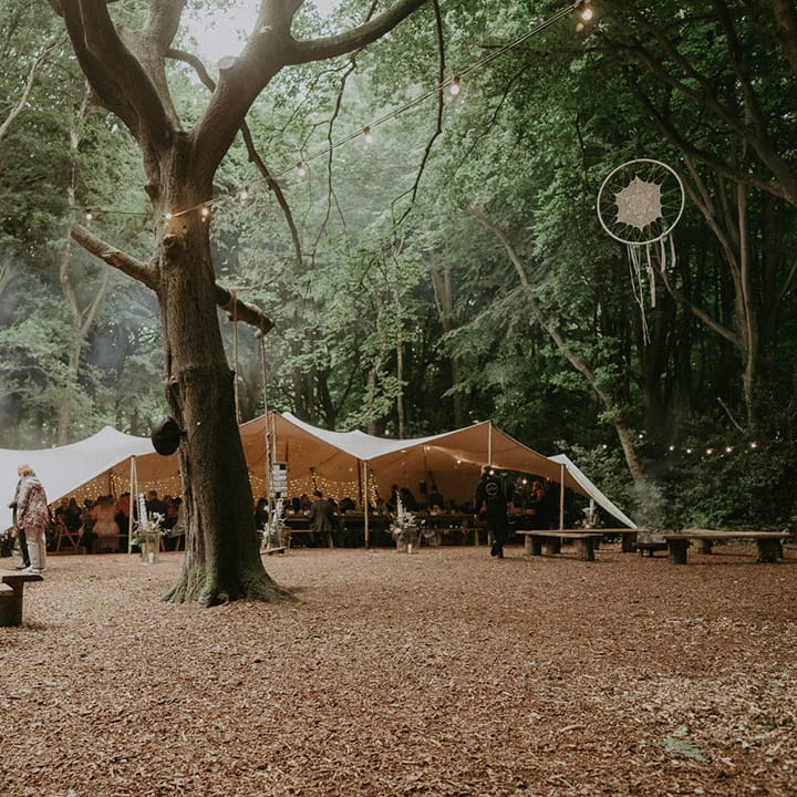 Lila's Wood woodland wedding with DIY decorations and bunting decorating the outdoor area 