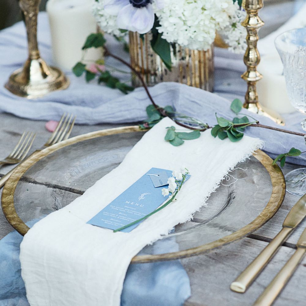 Clear charger plates with gold rim with menu and place name stationery for rustic wedding 