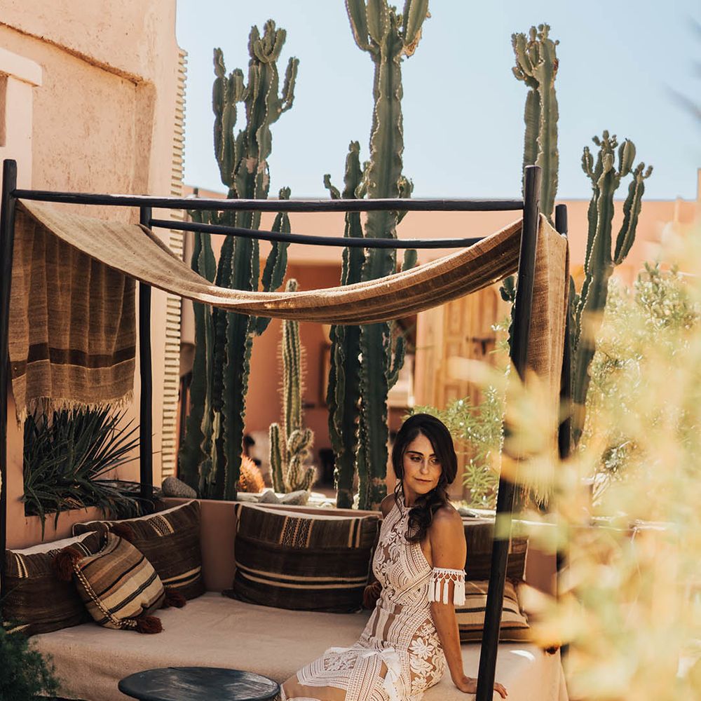 Bride sits down in her halter neck Rue De Seine wedding dress 