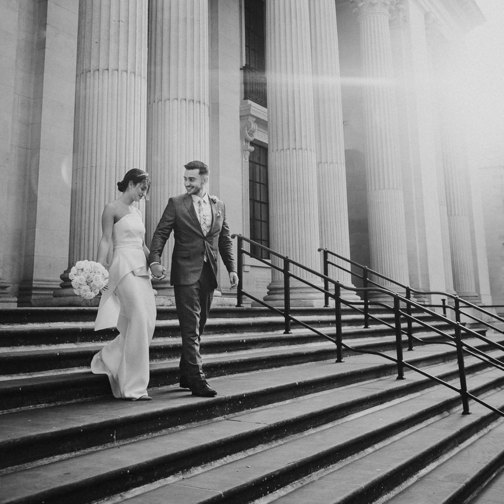 Bride and groom walking down the steps at Old Marylebone Town Hall wedding