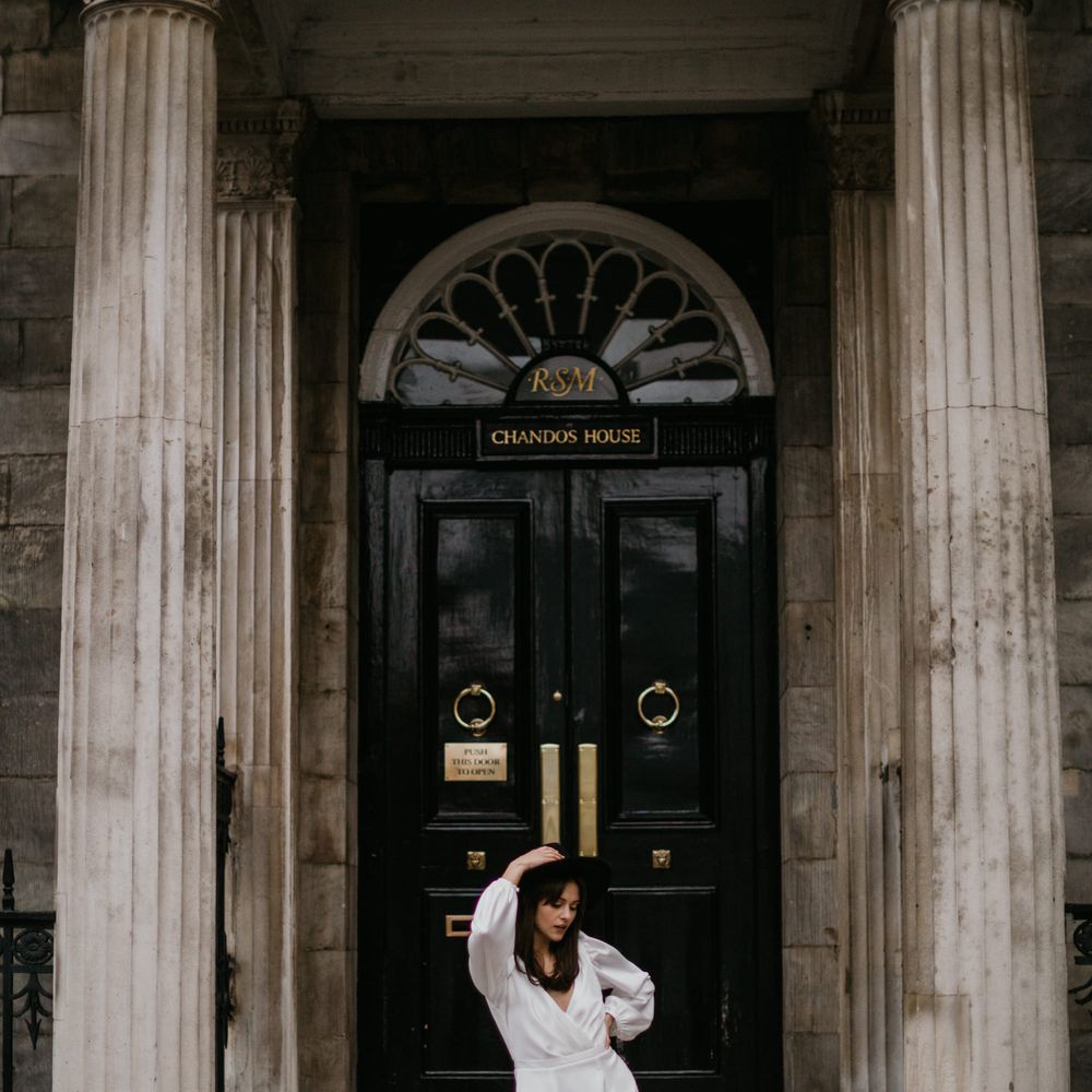Bride in boots and fedora at town hall wedding 