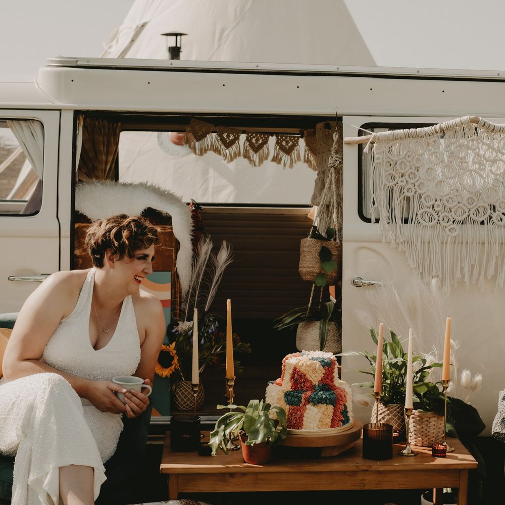 LGBT wedding with brides sitting by a campervan 