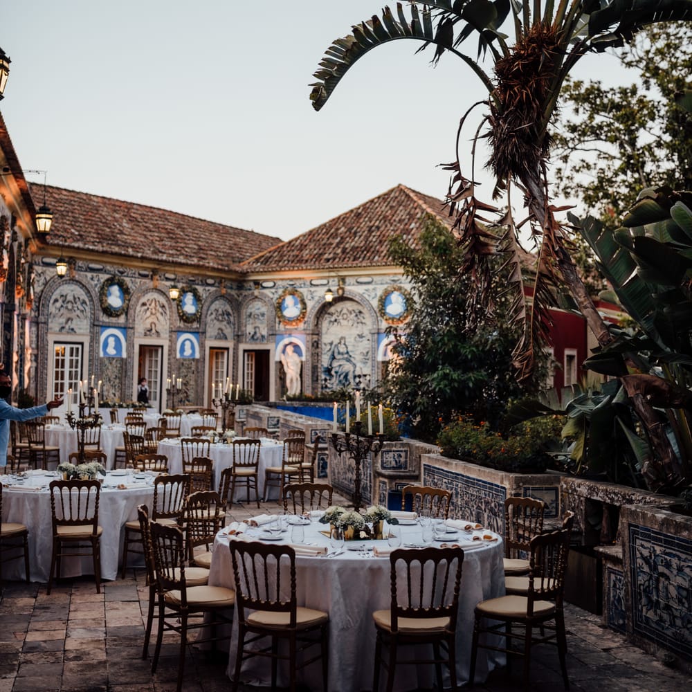 Colourful outdoor reception with classic tiling along the side and palm trees
