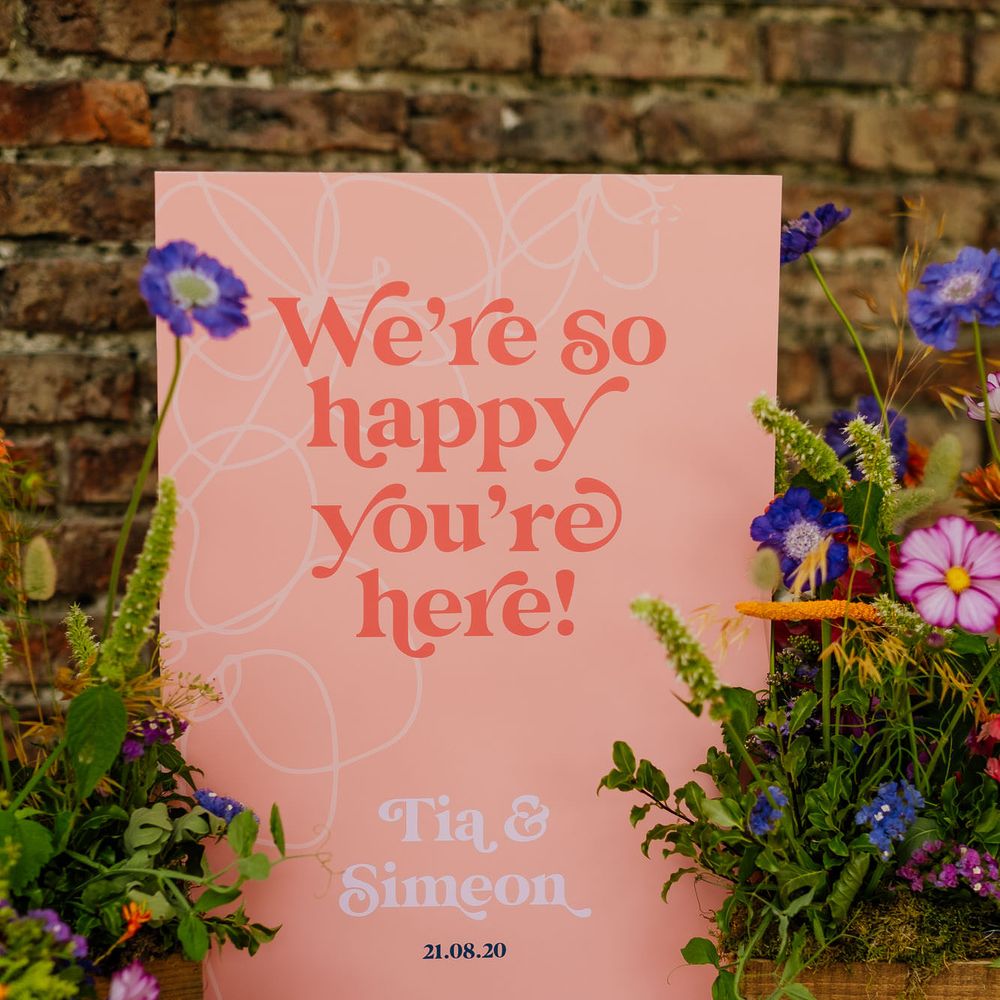 Vibrant "We're happy you're here" wedding welcome sign for fiesta theme wedding