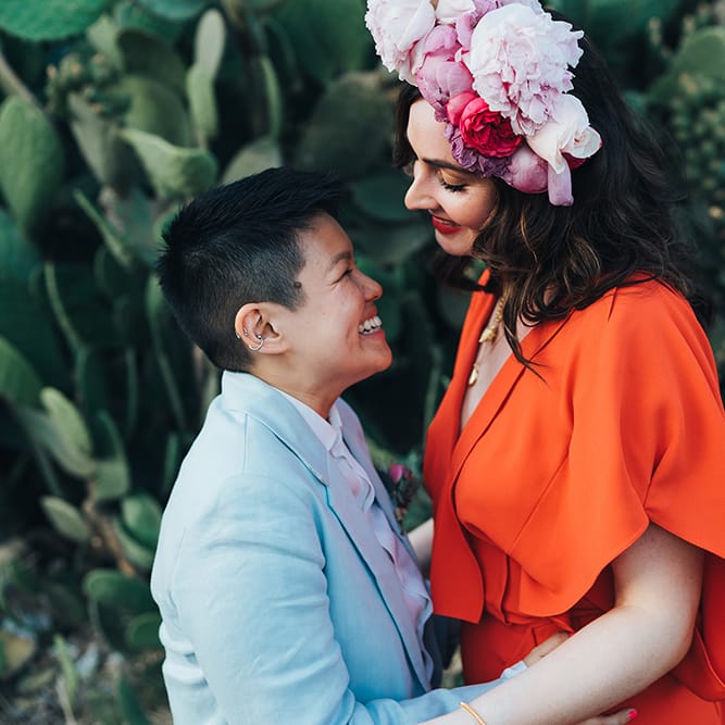 Brides look lovingly at one another during post wedding photoshoot