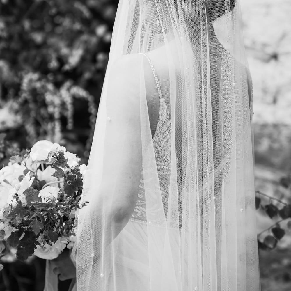 Bride in a pearl embellished wedding veil and laurel headdress 