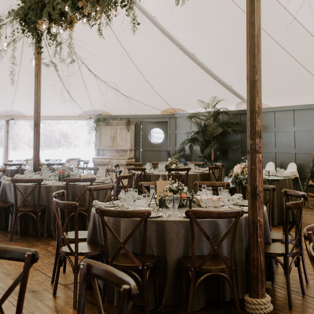Tipi wedding venue with sage green colour and floral arches throughout