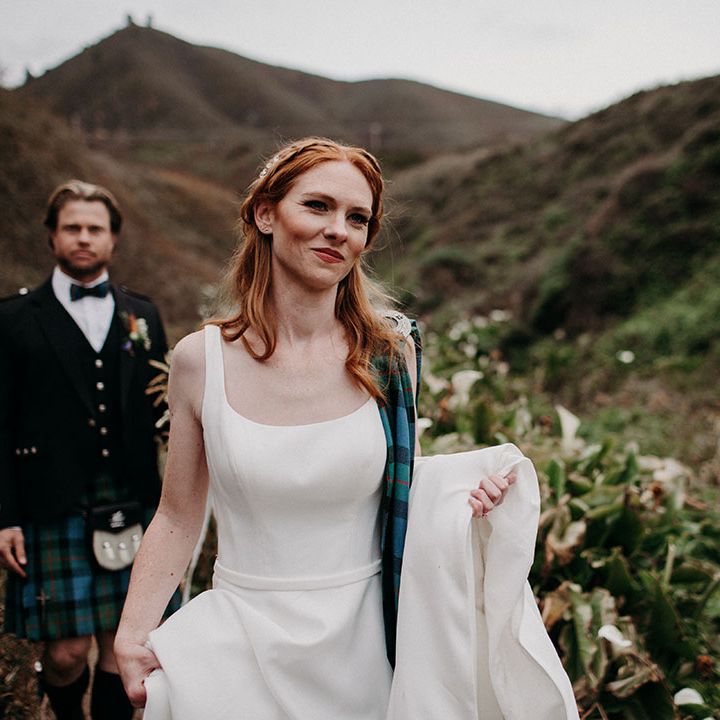 Beautiful bride with ginger hair in a princess wedding dress with natural wedding makeup and half up half down wedding hairstyle 