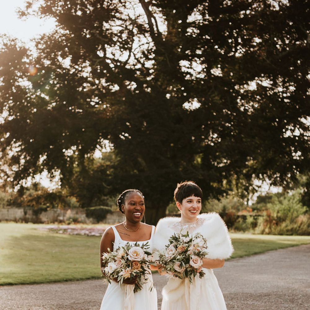 LGBTQI+ wedding at Elmore Court With Black bride in a Essense of Australia wedding dress and bride with short hair in a Anna Kara wedding dress 
