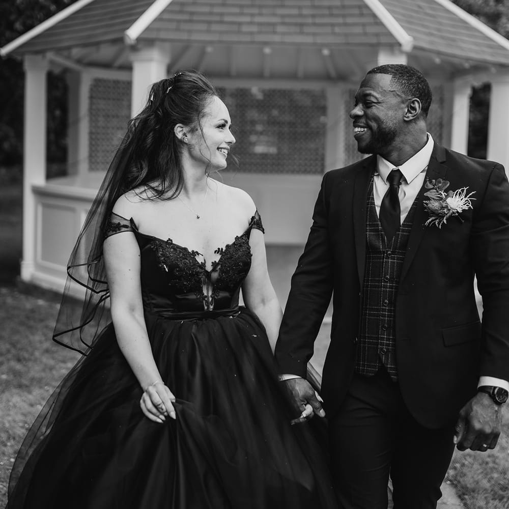 Bride & groom walk hand in hand after wedding ceremony 
