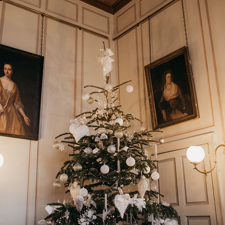 Christmas tree decorated with silver theme complete with white ribbon 