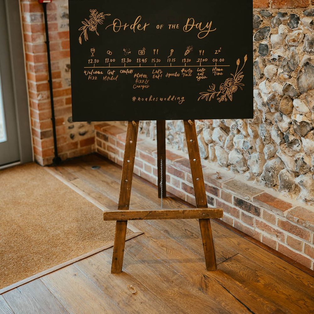 Black and gold rectangle order of the day wedding sign 