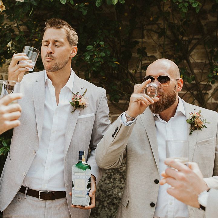 Groom takes some shots with his groomsmen before the wedding 