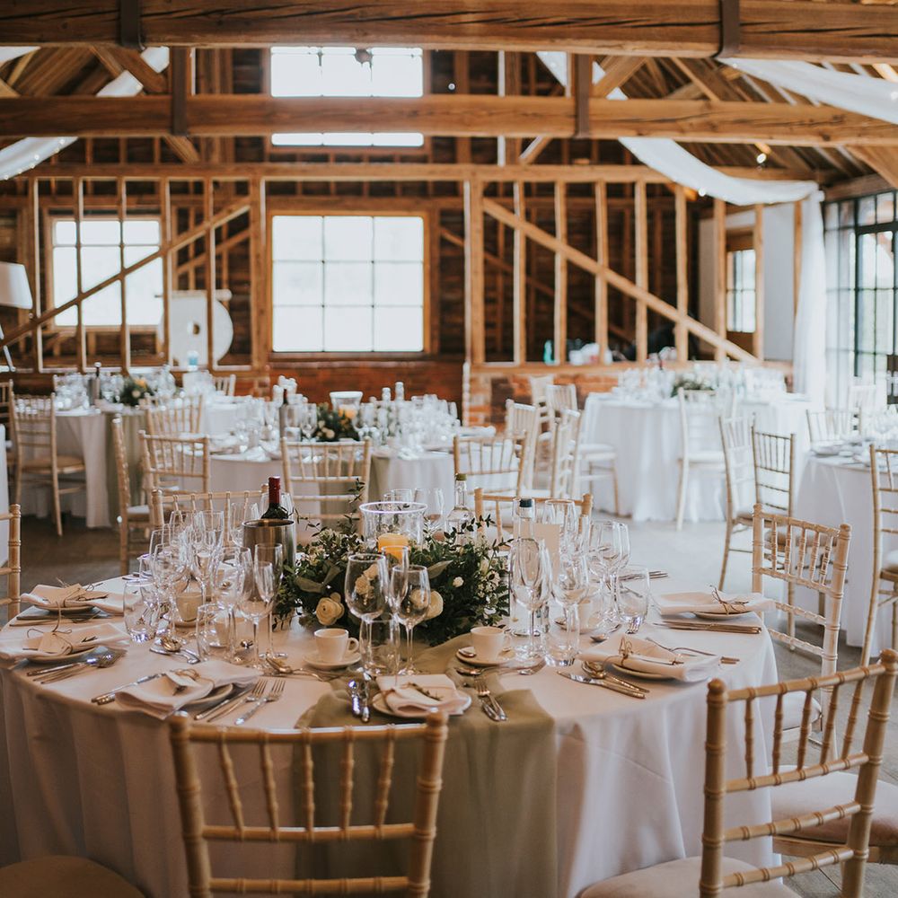 Stanlake Park barn wedding reception venue with white wedding drapes and cosy lighting 
