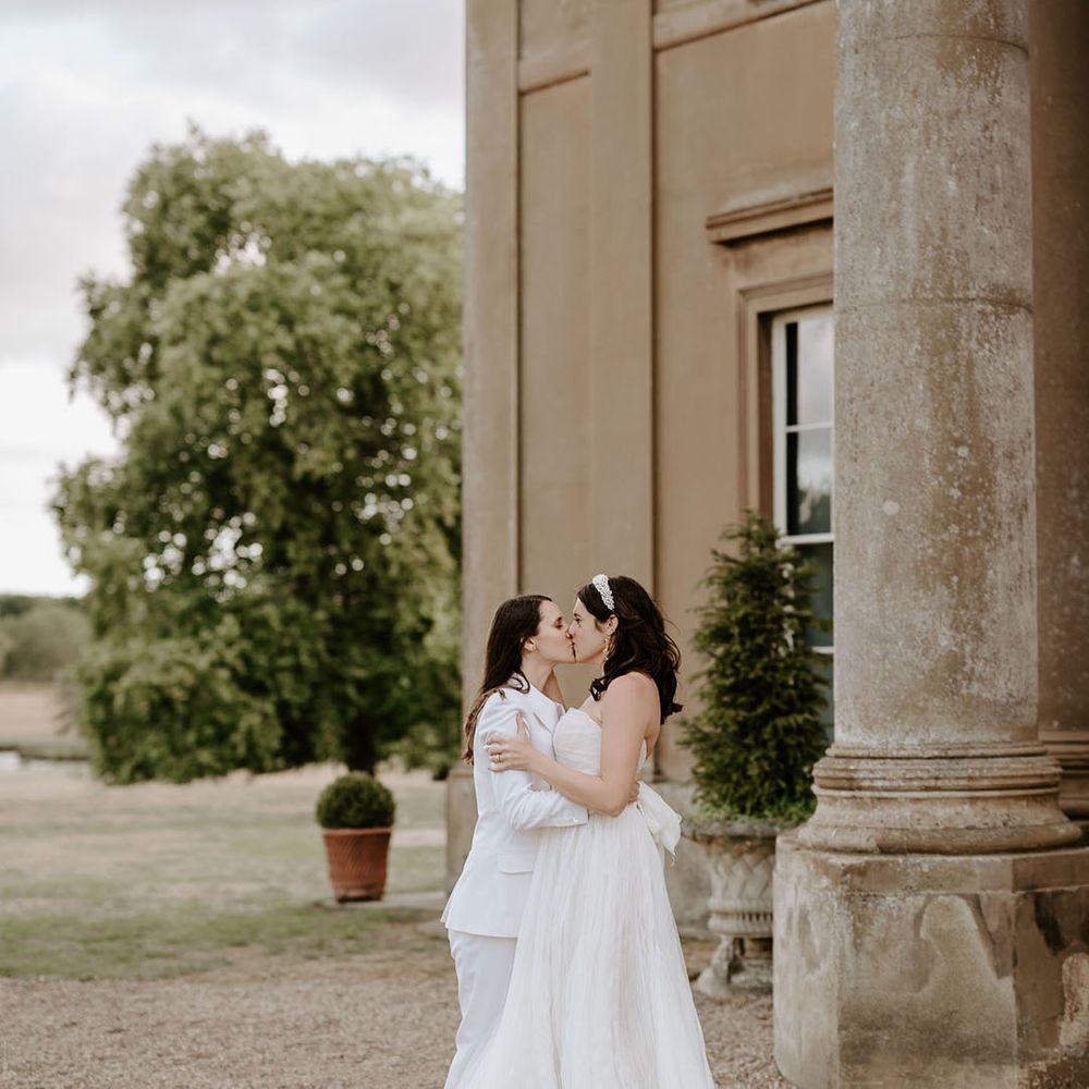 The brides share a kiss at the Wilderness Reserve wedding venue 