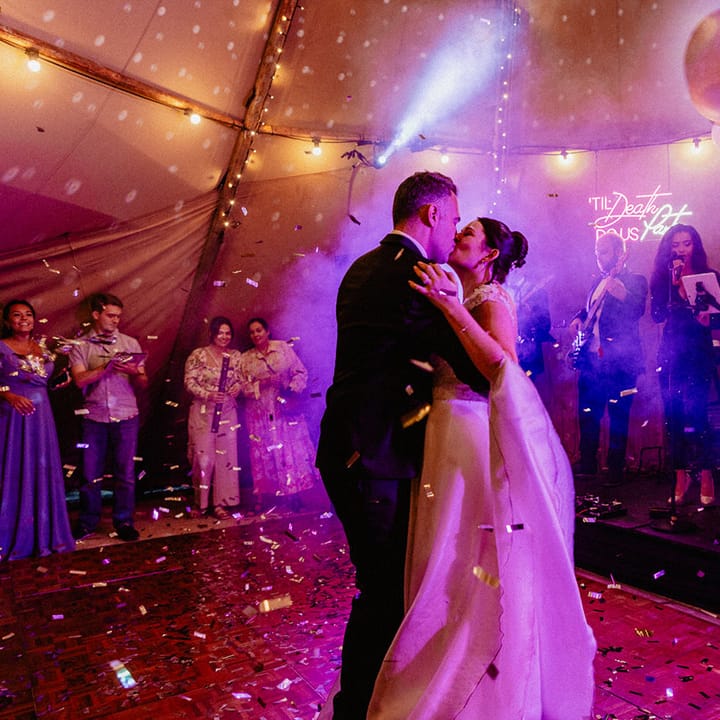 Neon wedding light with epic ballon decoration in the tipi as the bride and groom share their first dance together at Culden Faw Estate 