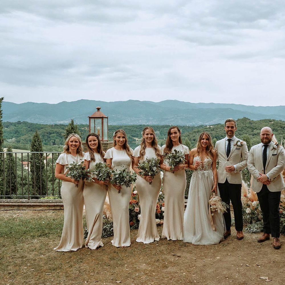 I do crew in off white bridesmaid dresses and linen suits with bride and groom at destination wedding