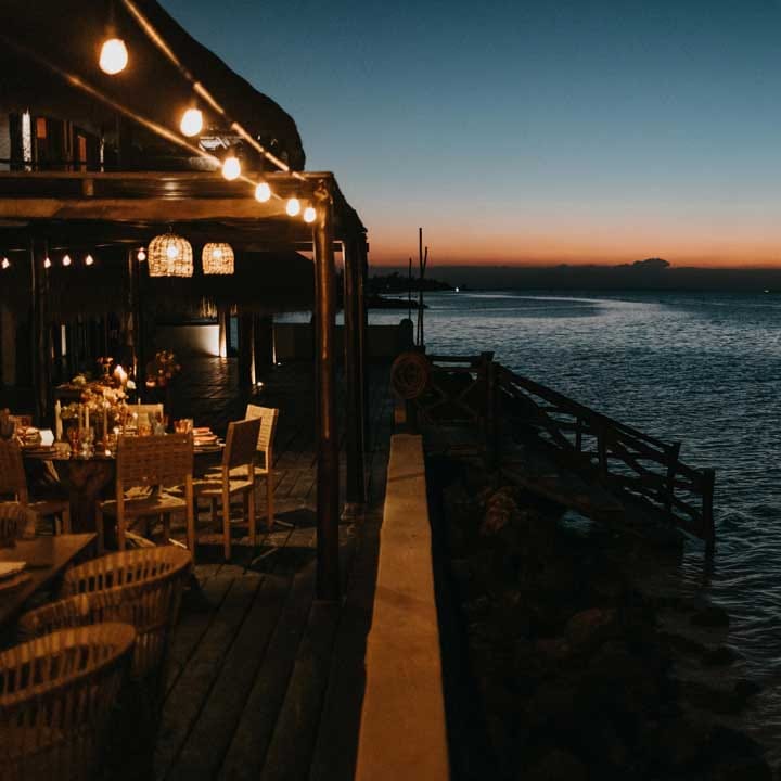 Wide shot of the Mexico beach destination hotel wedding venue at sunset 
