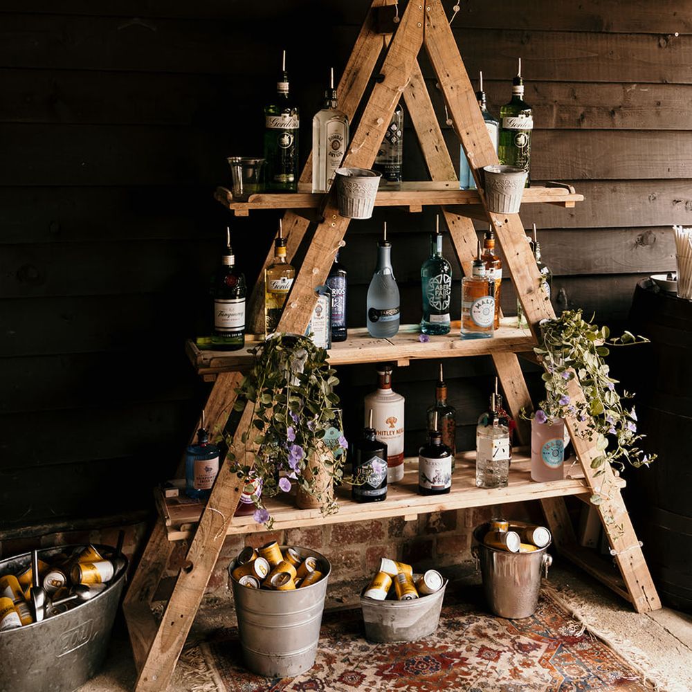 DIY G&T bar design with different brands of gin on shelves with pour spouts 