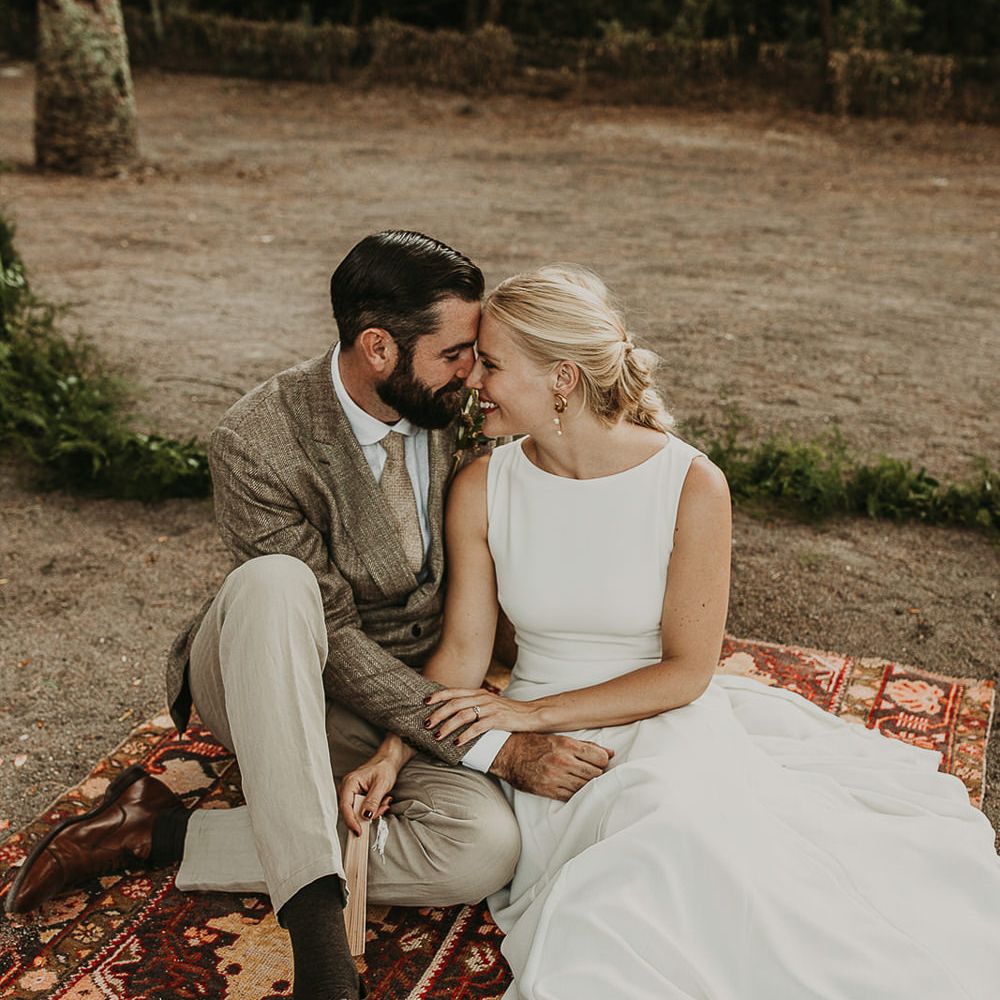Bride and groom portrait sitting on a Persian rug