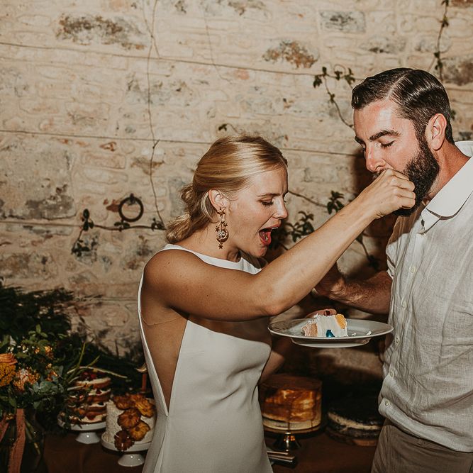 Bride feeing her groom cake at Andalusia wedding