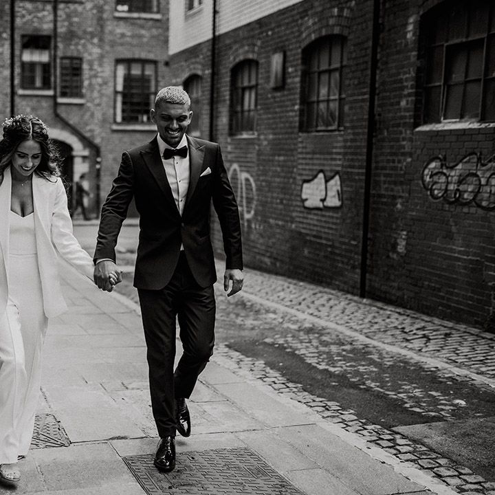 Black and white bride and groom urban portrait around Sheffield with bride in a three piece suit and groom in a tuxedo 