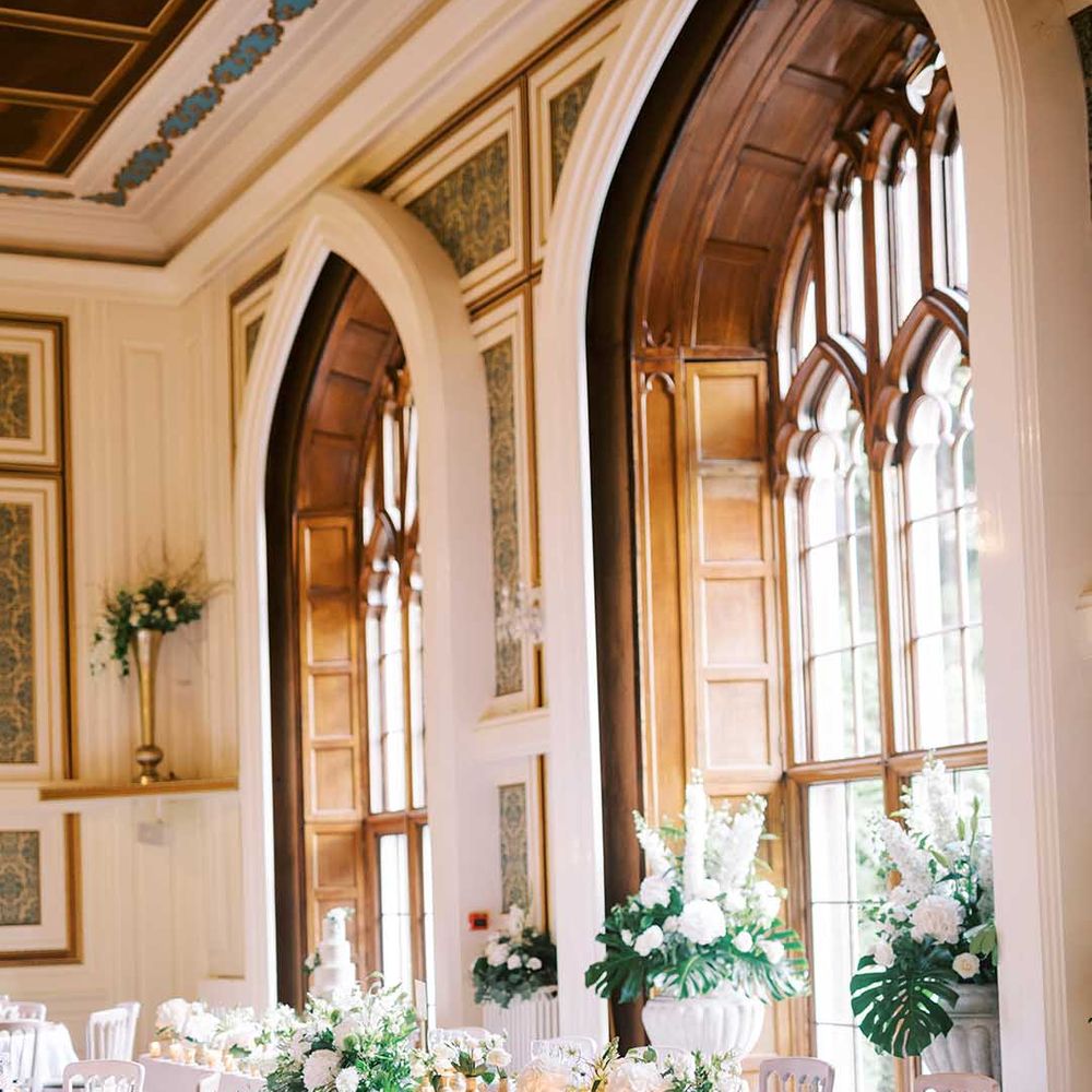 Top table at Drumtochty Castle reception with white and green wedding flowers 