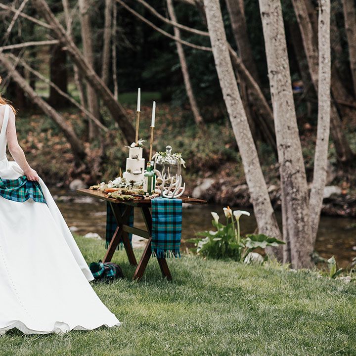 Bride and groom at their outdoor elopement with blue and green wedding tartan kilt and shawl 