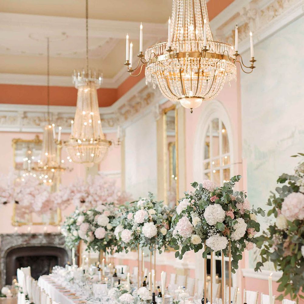Danesfield House wedding reception complete with large floral bouquets along table centre and blush pink colour scheme