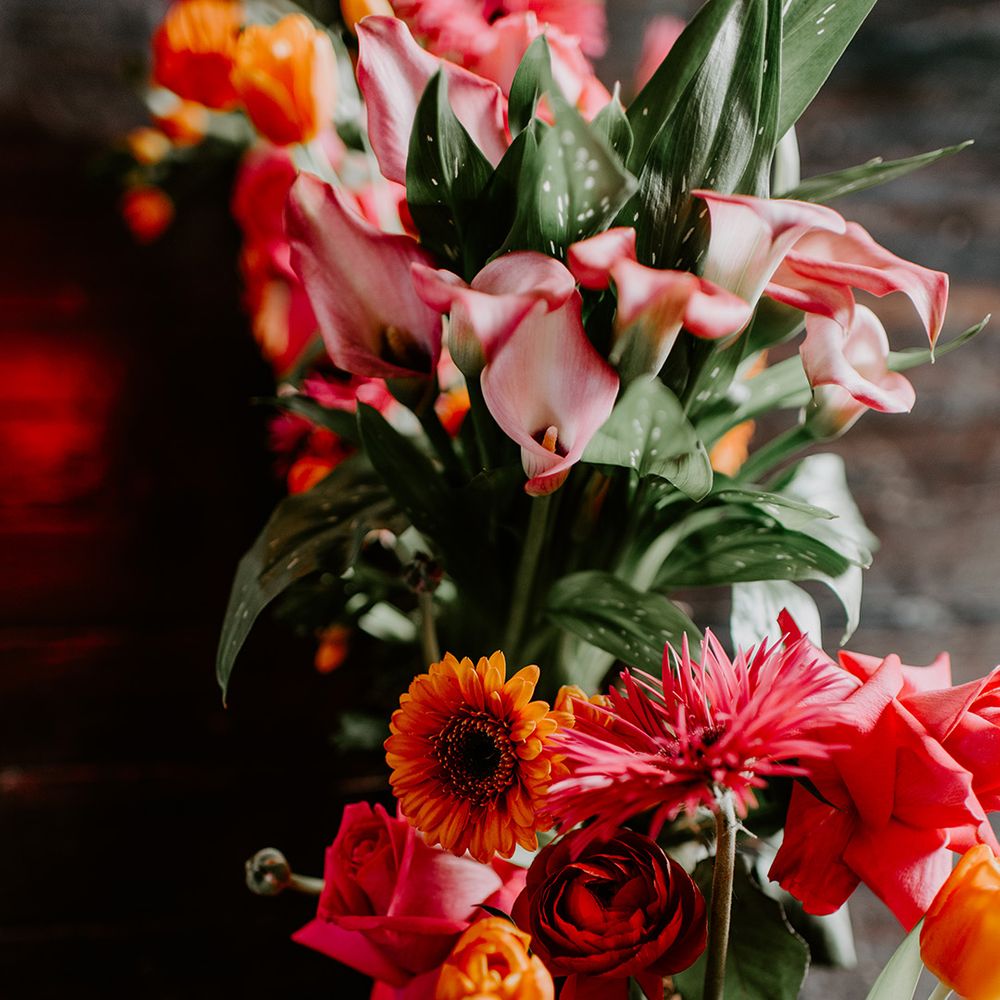Red, orange, pink and coral Calla Lilies, roses, tulips and Gerbera wedding flowers 