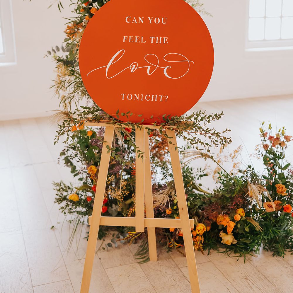 Burnt orange wedding sign can you feel the love tonight