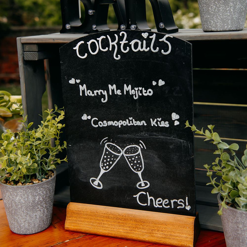 Outdoor cocktail bar with Cosmopolitans and Mojitos being served 